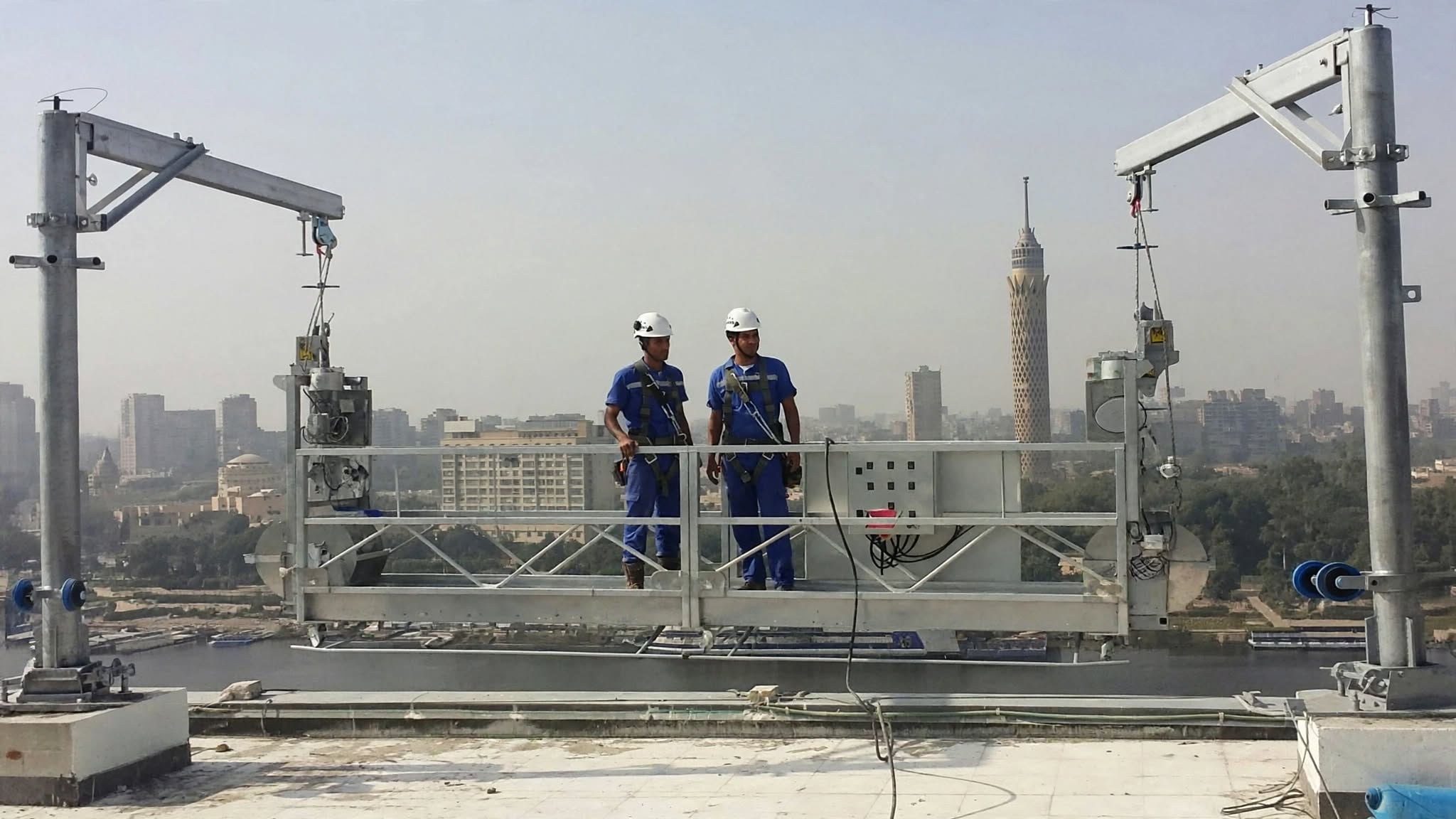 Rope-access workers descending a high-rise facade