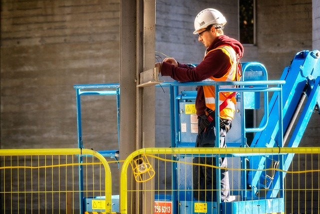 Vertical mast lift with a worker